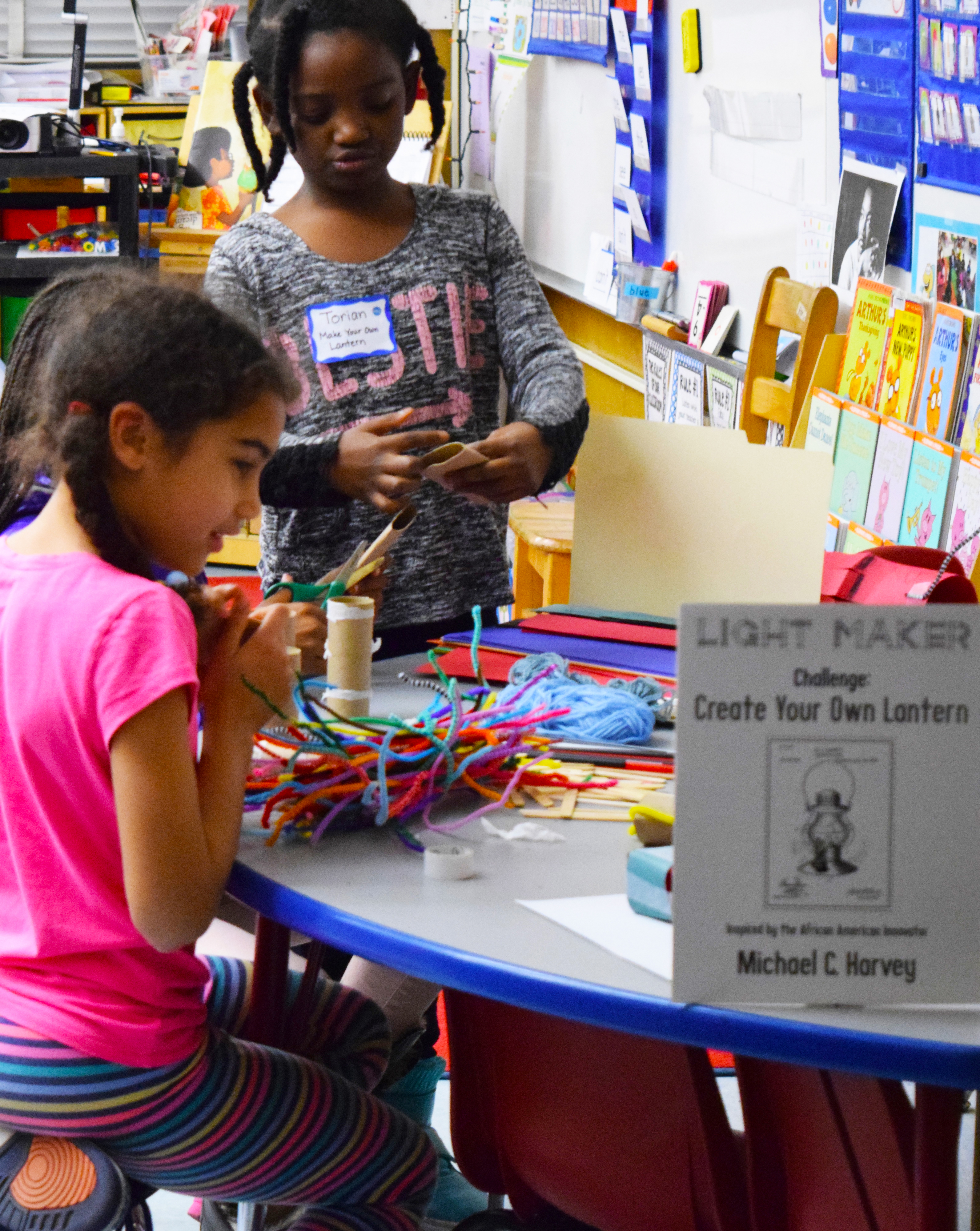 A first-grade student leads the lantern making station at Grass Valley Elementary