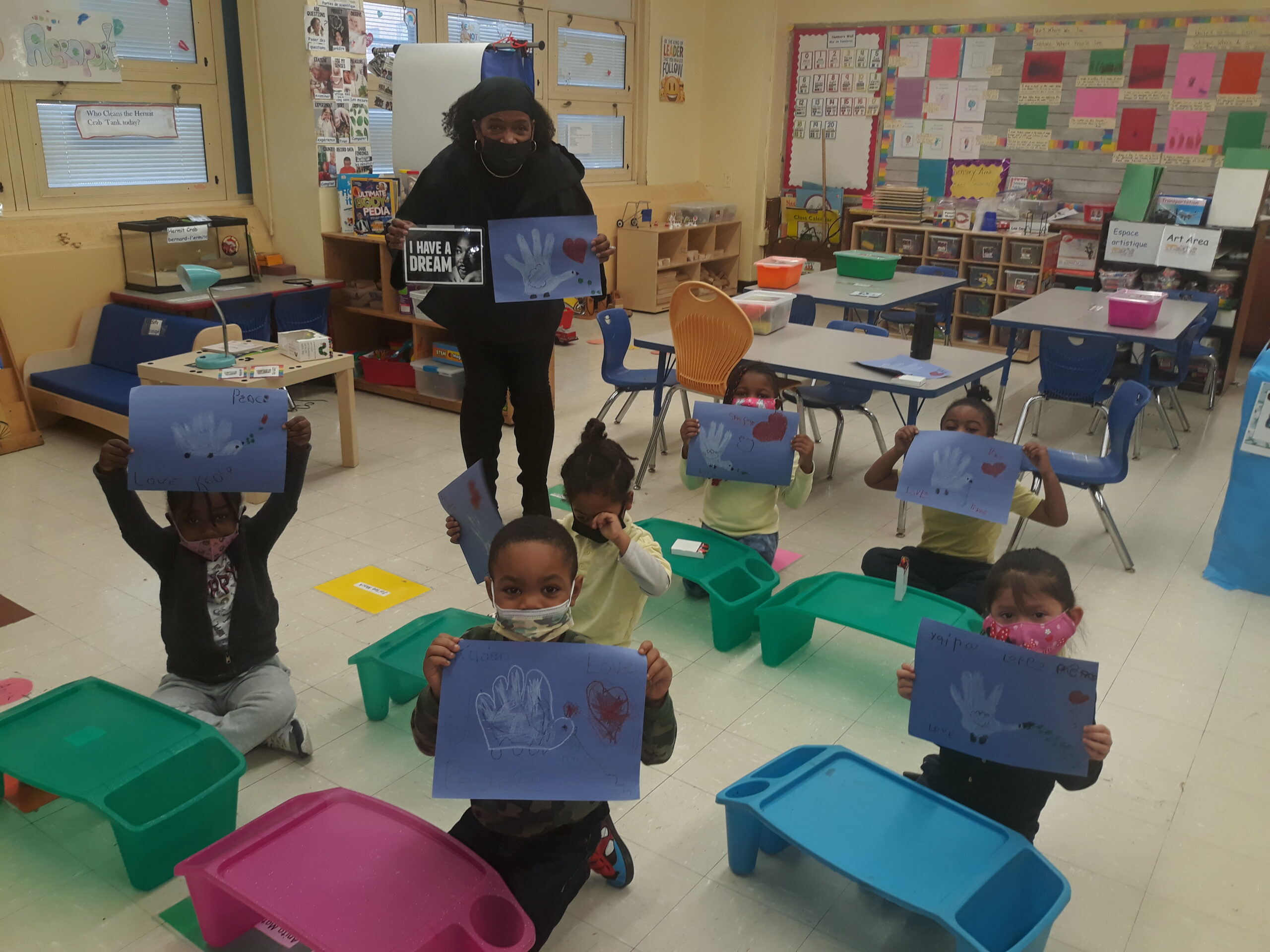 A photo of Ms. White and Kindergarten students honoring the legacy of Dr. Martin Luther King Jr.
